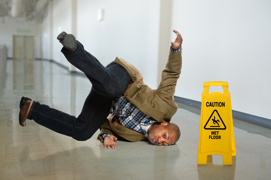 african-american-businessman-falling-on-wet-floor-in-office-toilet